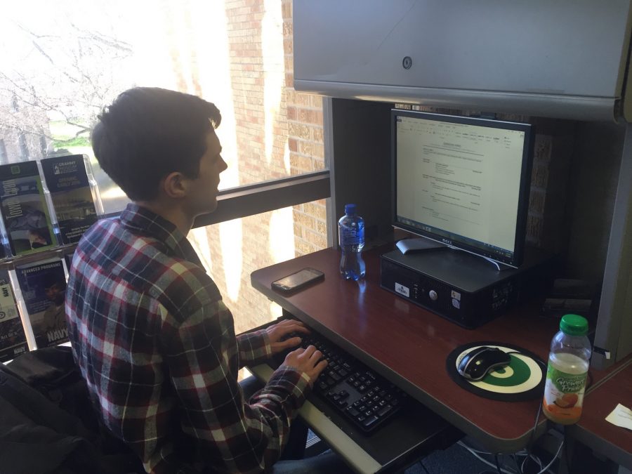 Aaron Payne working on resumes at his internship at Career Services.