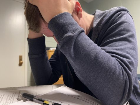 A student puts his head in his hands in frustration