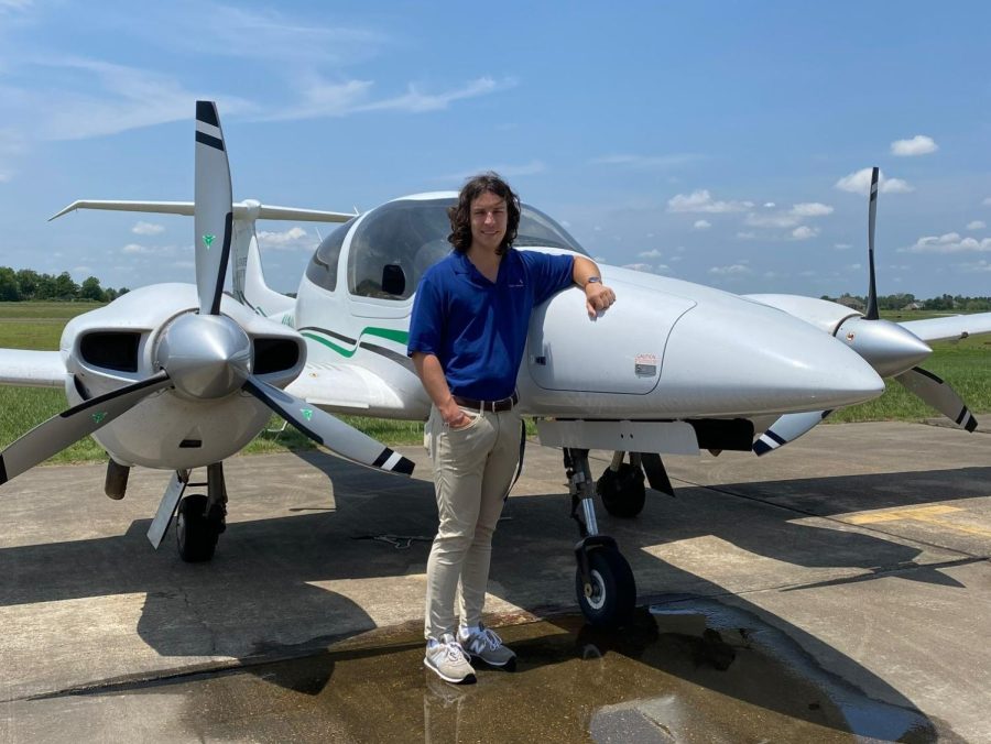 Senior Aviation Student Kaiden Holt poses next to a DA42 Airplane at the Delta State Airport.